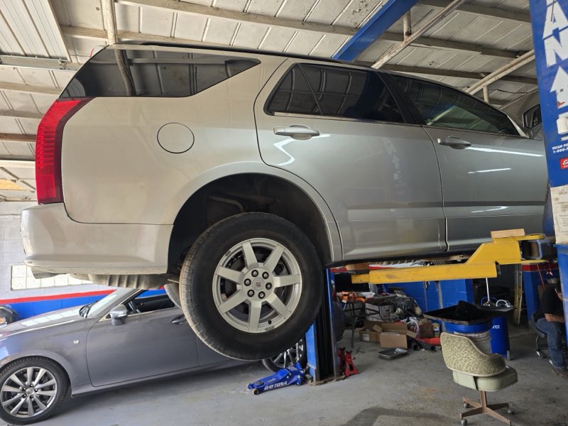 Merlin's Auto Repair & Sales - SUV on the lift
